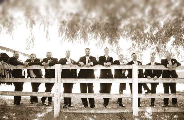 Groomsmen standing behind the fence