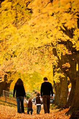 Family walking in fall leaves