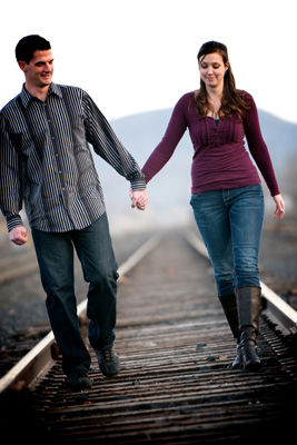 Couple walking on train tracks